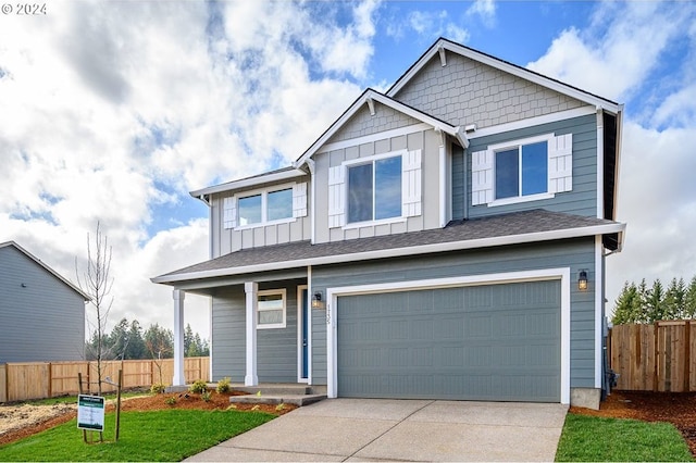 view of front facade featuring a garage, board and batten siding, driveway, and fence