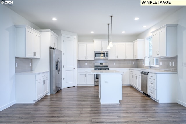 kitchen with a center island, hanging light fixtures, white cabinets, and stainless steel appliances