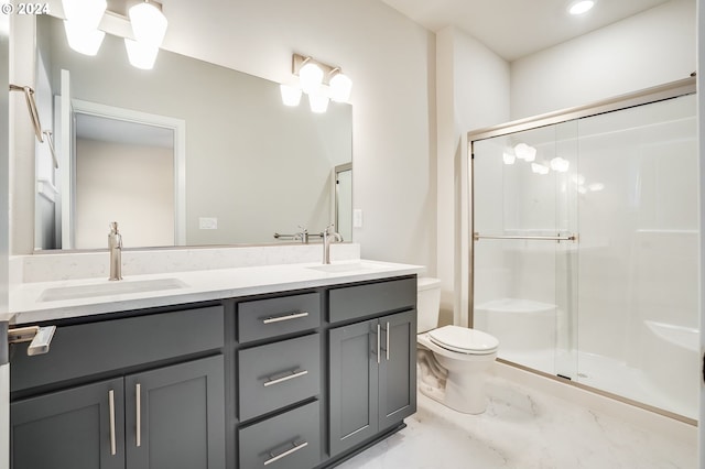 full bath with toilet, a shower stall, double vanity, and a sink