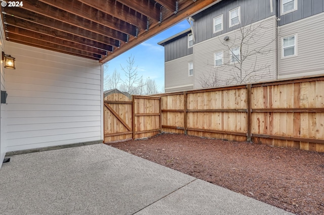 view of yard featuring a patio area, a gate, and fence