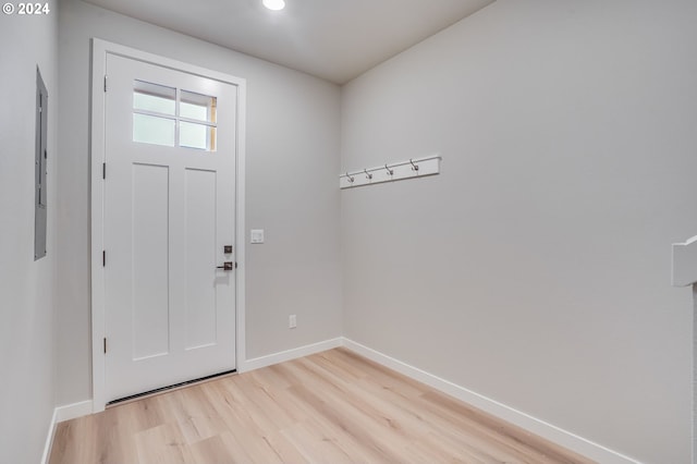 foyer entrance with light wood finished floors and baseboards