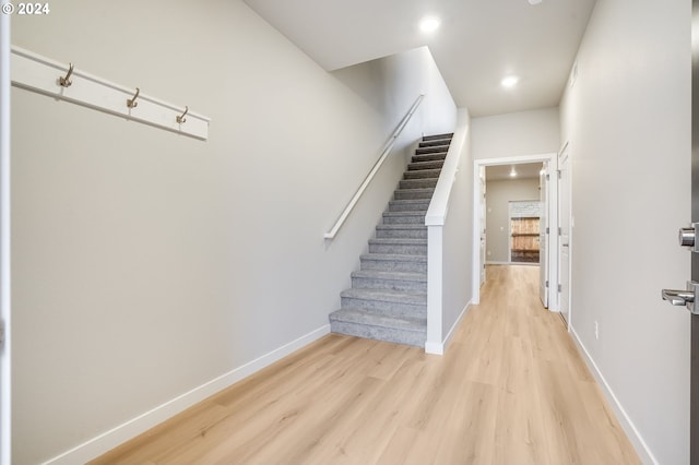 stairs featuring recessed lighting, wood finished floors, and baseboards