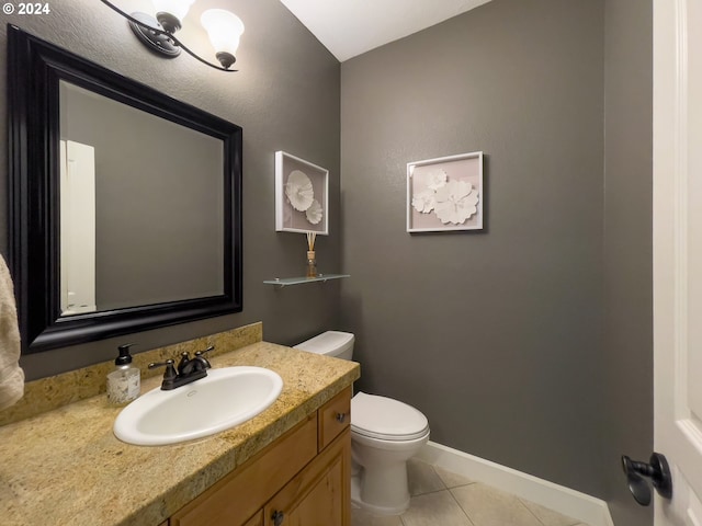 bathroom with tile patterned flooring, vanity, and toilet