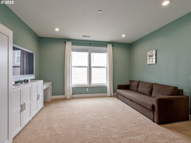 unfurnished bedroom with light colored carpet and a closet