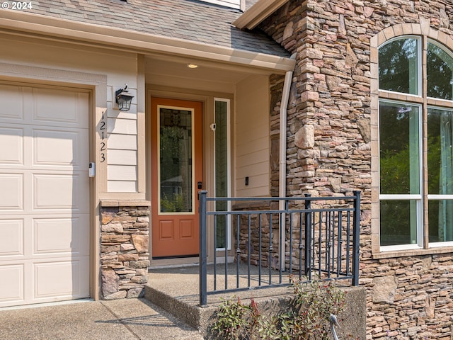 view of exterior entry featuring a garage