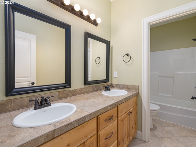 full bathroom featuring toilet, shower / bathing tub combination, vanity, and tile patterned floors