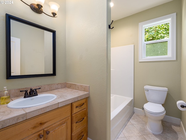 bathroom with toilet, vanity, and tile patterned floors