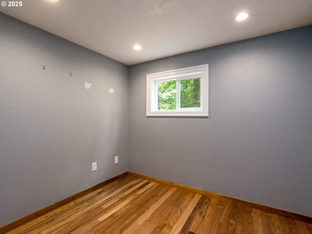 clothes washing area featuring hardwood / wood-style flooring and washer and clothes dryer