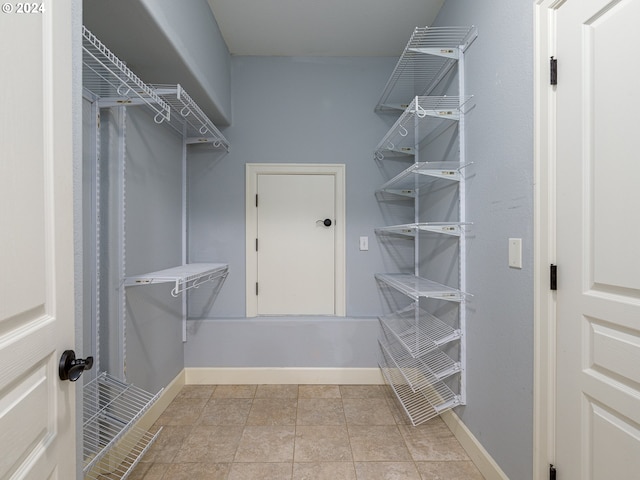 walk in closet featuring light tile patterned floors