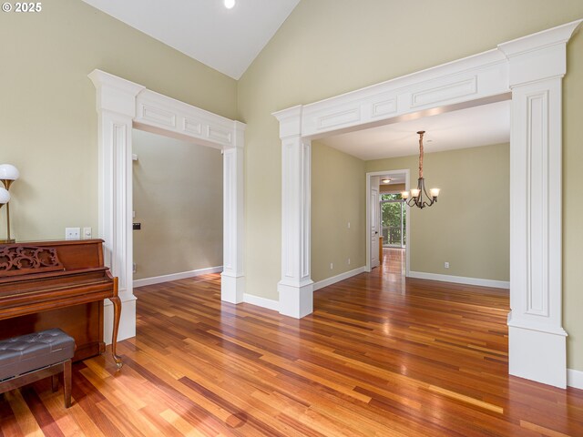 stairway with ornate columns and hardwood / wood-style flooring