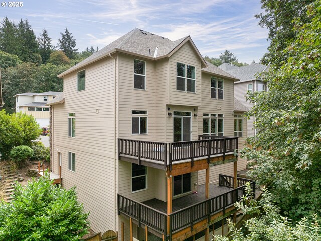 rear view of house featuring a deck