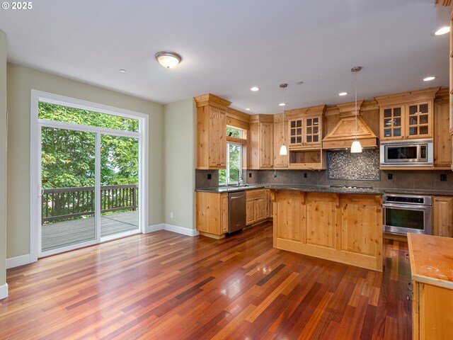 empty room featuring high vaulted ceiling, decorative columns, an inviting chandelier, and wood-type flooring