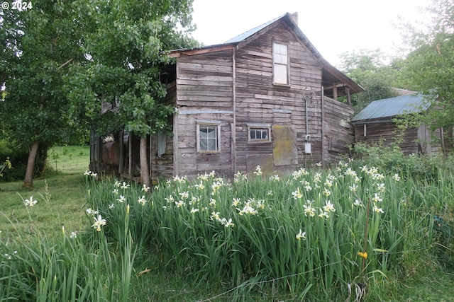 view of side of property featuring a storage unit