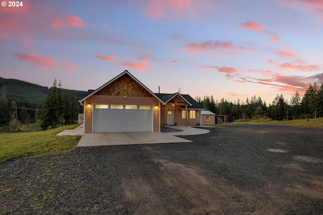 view of front of property featuring a yard and a garage