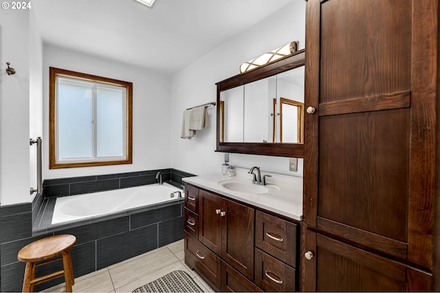 bathroom featuring vanity, tiled tub, and tile patterned flooring