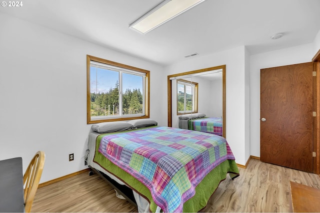 bedroom featuring a closet and light wood-type flooring