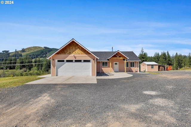 view of front facade featuring a garage and a mountain view