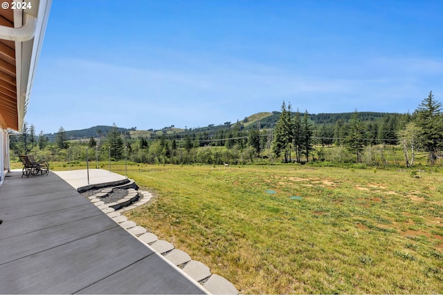 view of yard featuring a mountain view and a patio