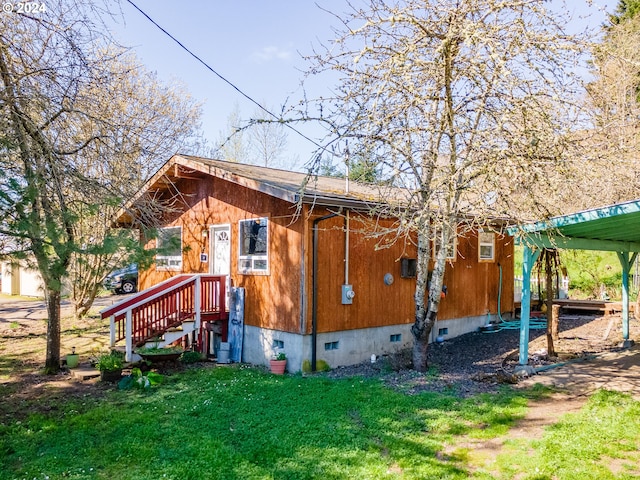 view of property exterior featuring a lawn and a carport