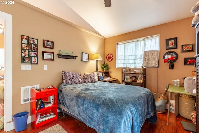 bedroom featuring ceiling fan, vaulted ceiling, and wood-type flooring