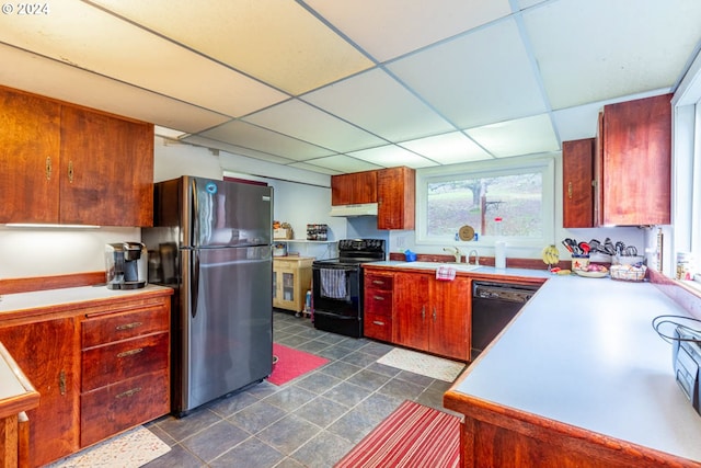 kitchen featuring a paneled ceiling, sink, and black appliances