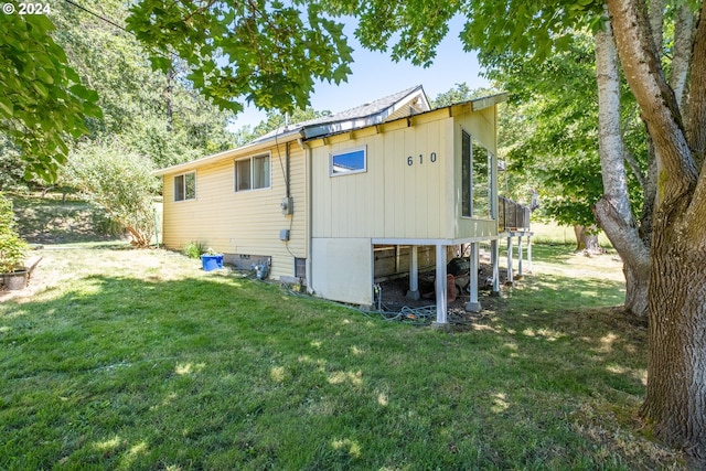 rear view of property with a yard