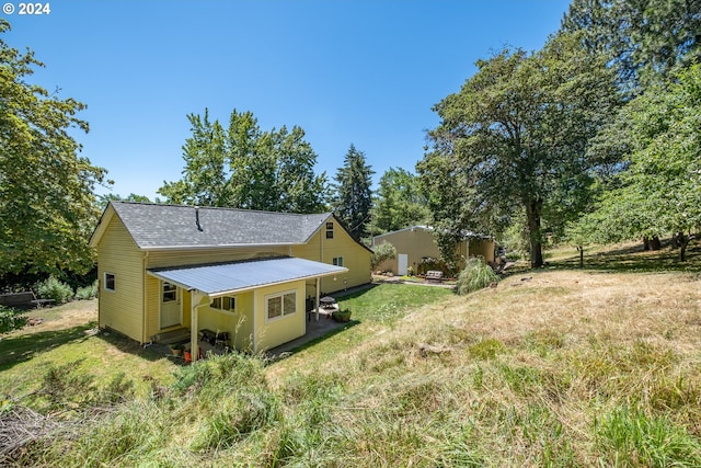 rear view of property with a lawn