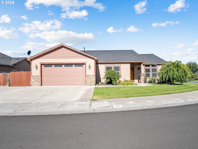 view of front of home featuring a front lawn and a garage