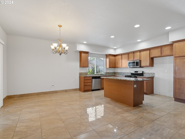 kitchen featuring a center island, light tile floors, hanging light fixtures, stainless steel appliances, and light stone countertops