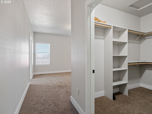 spacious closet featuring dark carpet