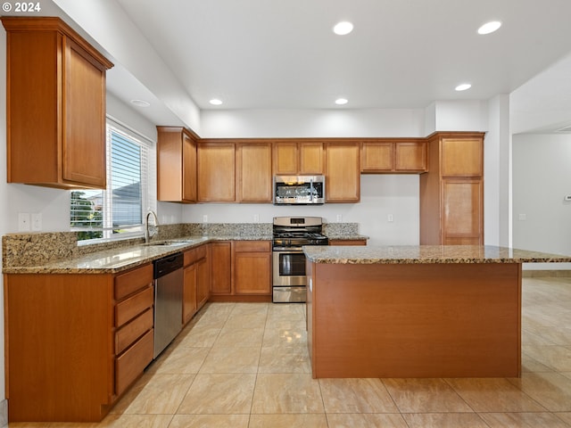 kitchen with stainless steel appliances, light tile floors, and light stone counters