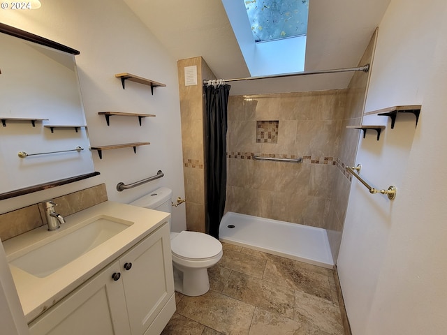 bathroom featuring vanity, a shower with curtain, toilet, and a skylight