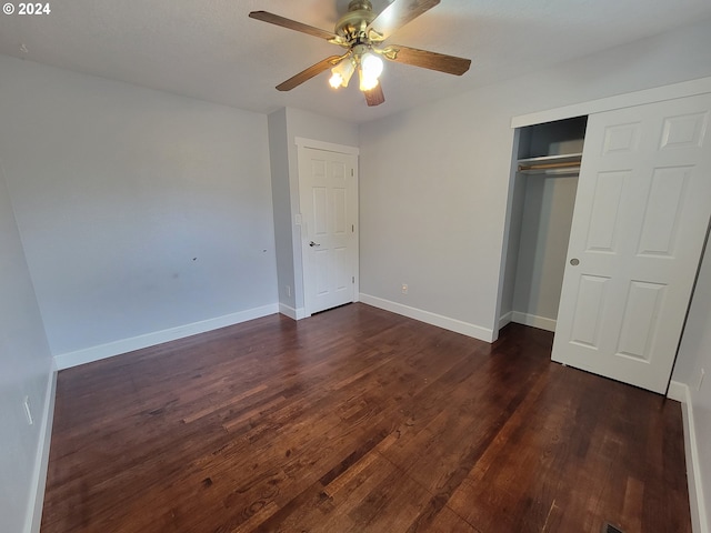 unfurnished bedroom with dark hardwood / wood-style floors, a closet, and ceiling fan