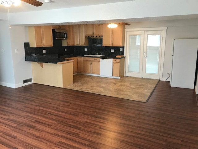 kitchen featuring kitchen peninsula, tasteful backsplash, ceiling fan, dark hardwood / wood-style flooring, and dishwasher