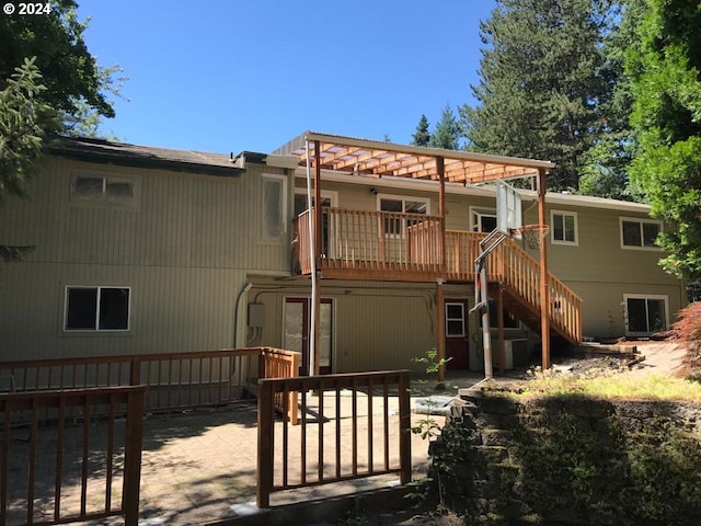 rear view of house featuring a deck