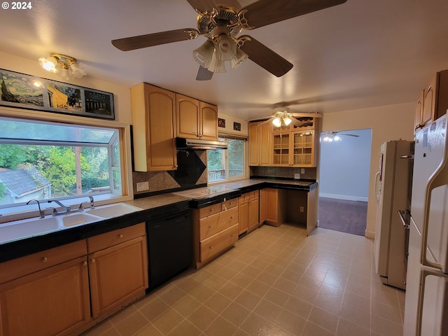 kitchen with a healthy amount of sunlight, black appliances, tasteful backsplash, and sink