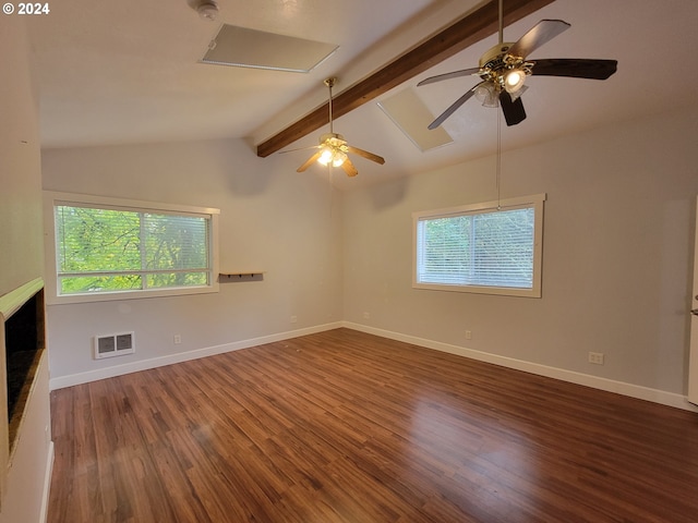 unfurnished room featuring vaulted ceiling with beams, dark hardwood / wood-style floors, and a healthy amount of sunlight