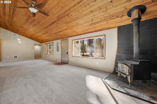 unfurnished living room featuring ceiling fan, wooden ceiling, carpet flooring, vaulted ceiling, and a wood stove