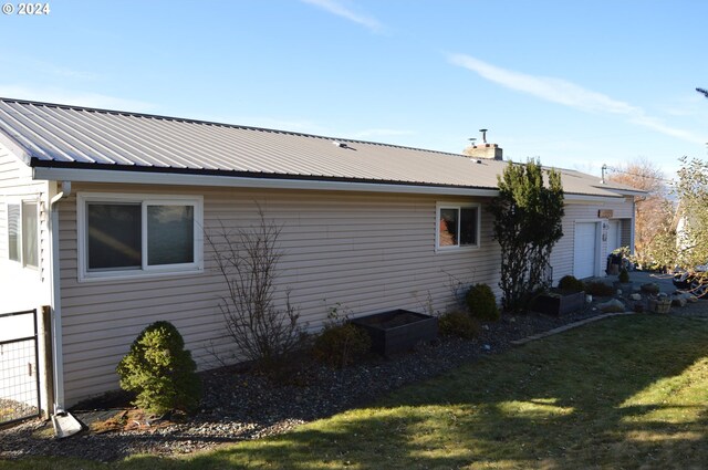 view of side of home featuring a lawn