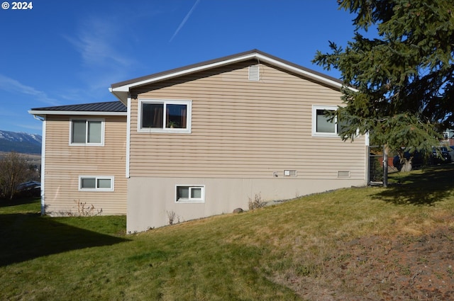 view of side of home with a lawn