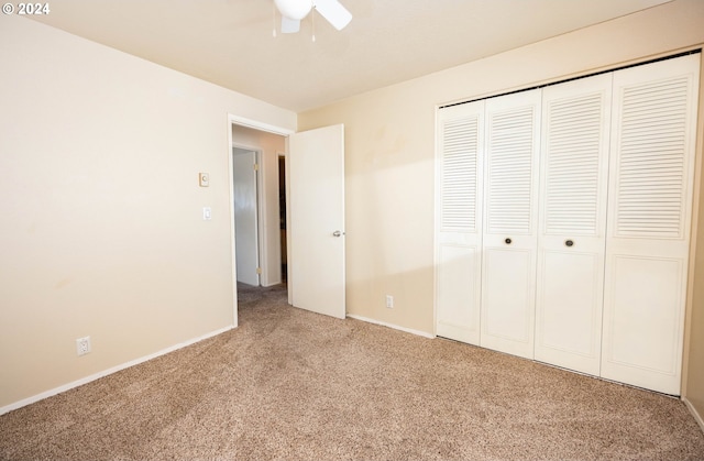 unfurnished bedroom featuring ceiling fan, carpet floors, and a closet