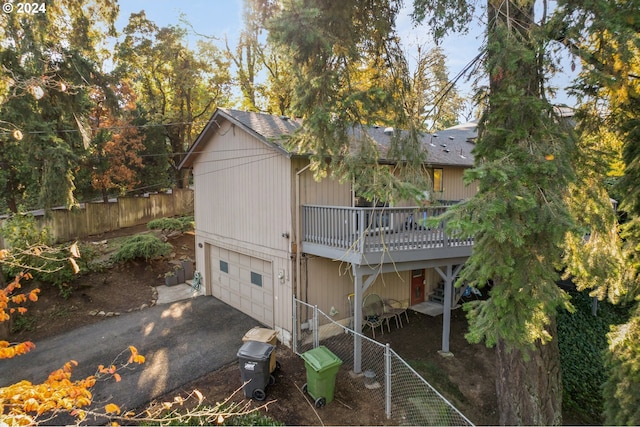 exterior space featuring a wooden deck and a garage