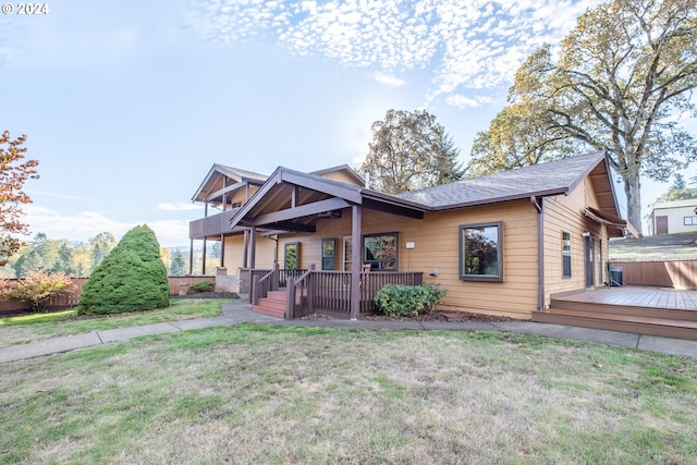 view of front of house featuring a hot tub, a front lawn, and a deck