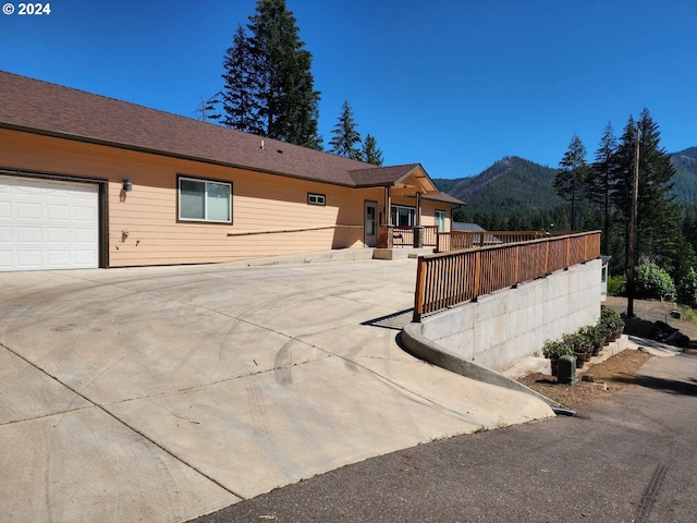 single story home featuring a mountain view and a garage