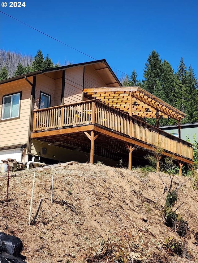 view of property exterior with a wooden deck