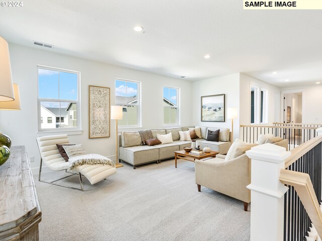 living room featuring light colored carpet and plenty of natural light