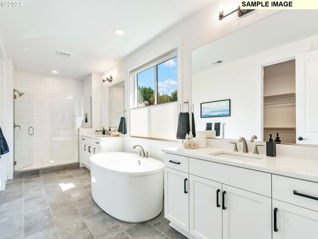 bathroom featuring vanity, tile floors, and shower with separate bathtub