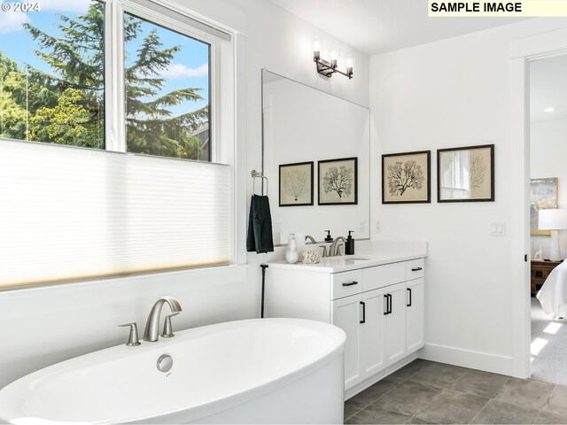 bathroom with tile floors, vanity, and a tub