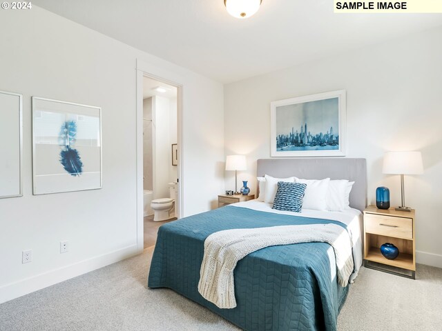 bedroom with light colored carpet and connected bathroom