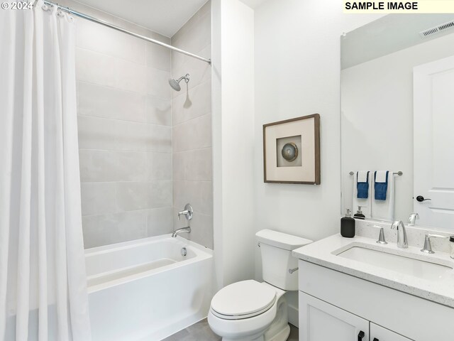 full bathroom with shower / bath combo, vanity with extensive cabinet space, and toilet